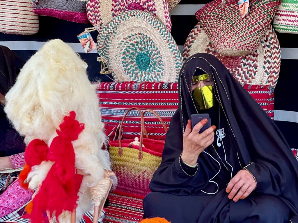 A participant holding a phone while seated in a heritage setting